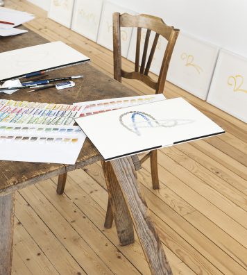 La table de travail de l’artiste. On y voit des dessins des sculptures fontaines de Versailles.