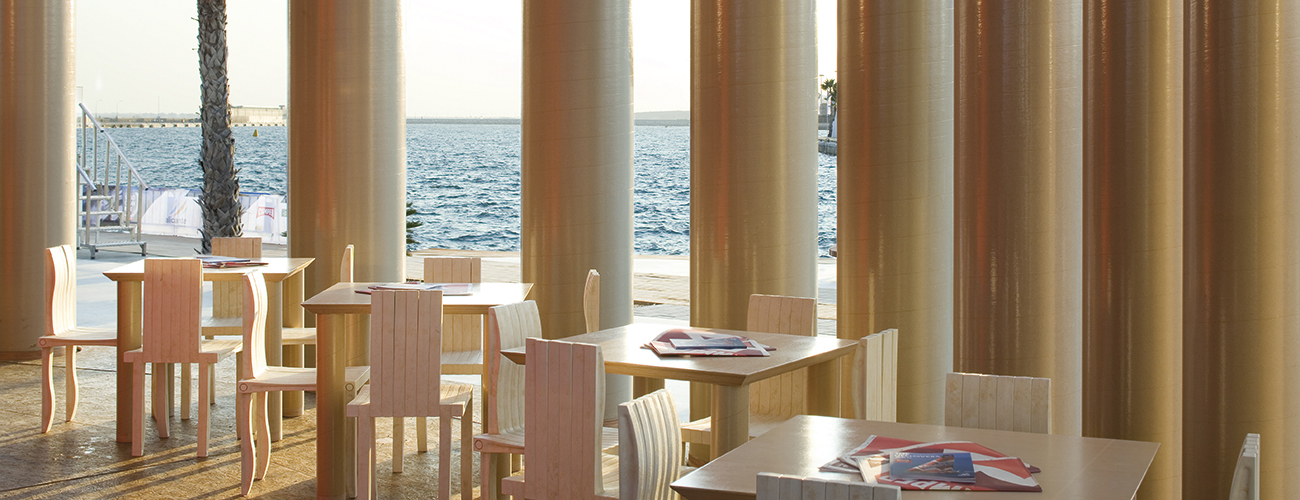 Camper Traveling Pavilion à Alicante en Espagne. Un café est aménagé sous le toit du pavillon. Les meubles ont été dessinés par Shigeru Ban.